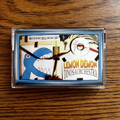 Photograph of a cassette of Dinosaurchestra by Lemon Demon