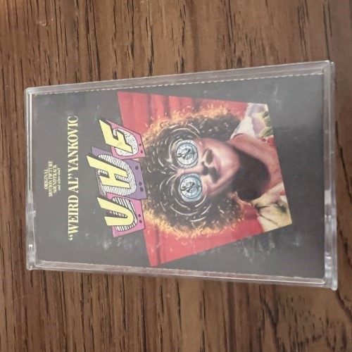 Photograph of a cassette of UHF: Original Motion Picture Soundtrack And Other Stuff by Weird Al Yankovic